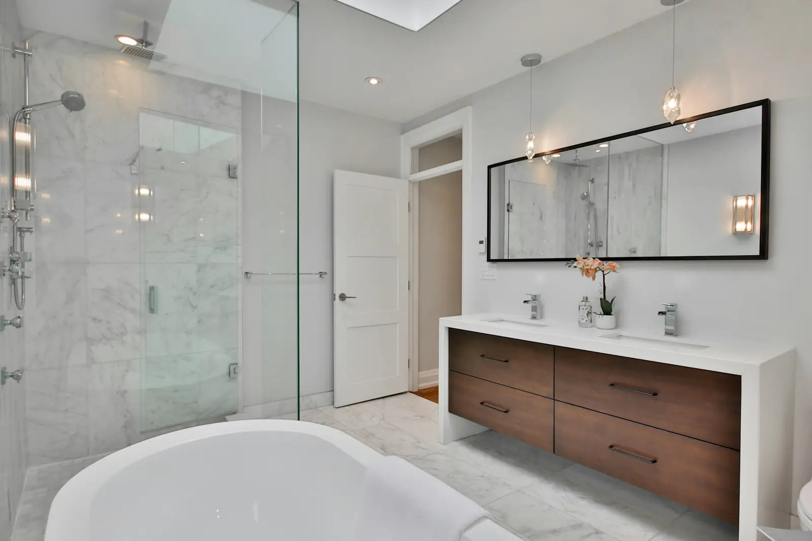 Large bathroom with a freestanding bath and walk-in glass shower