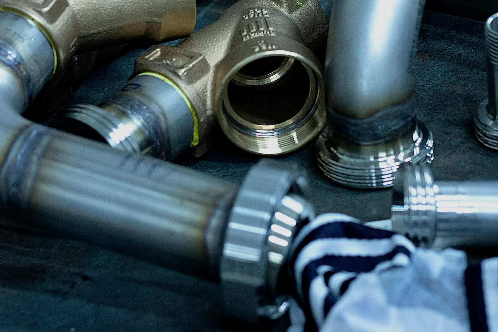 Brass and steel plumbing fittings and pipe connectors