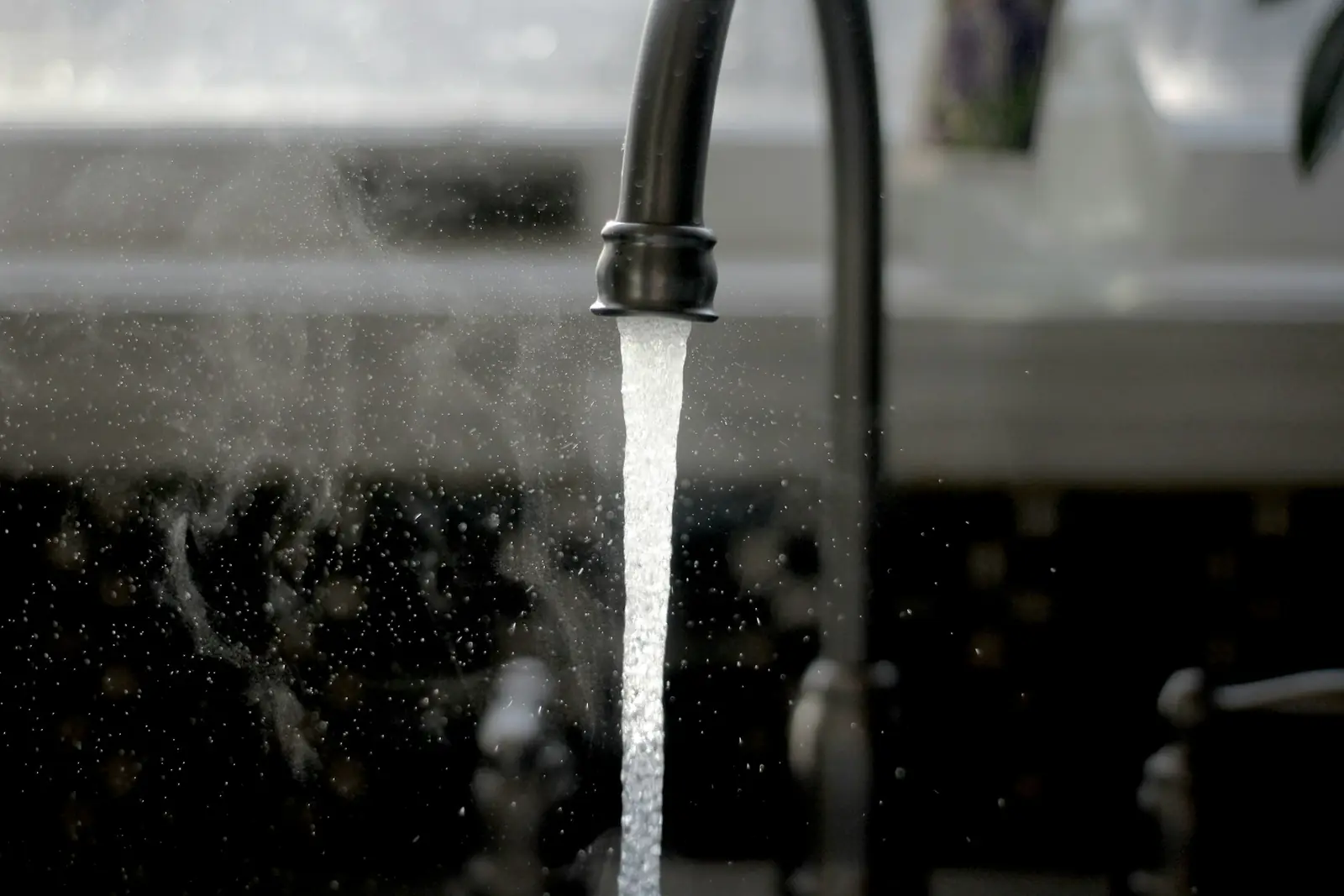 Kitchen tap running water into a sink