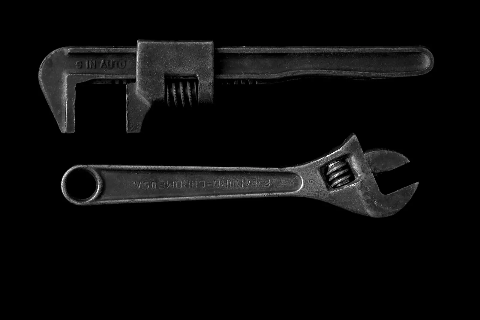 Pipe wrench and adjustable spanner, two of a plumber's essential tools