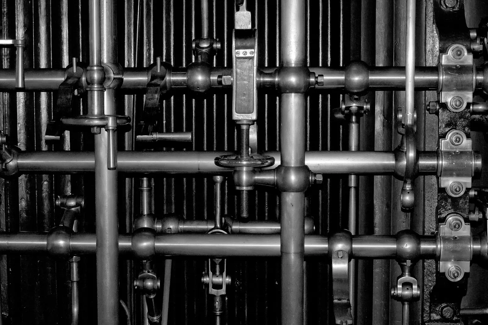 Dense run of metal pipes, valves and fittings
