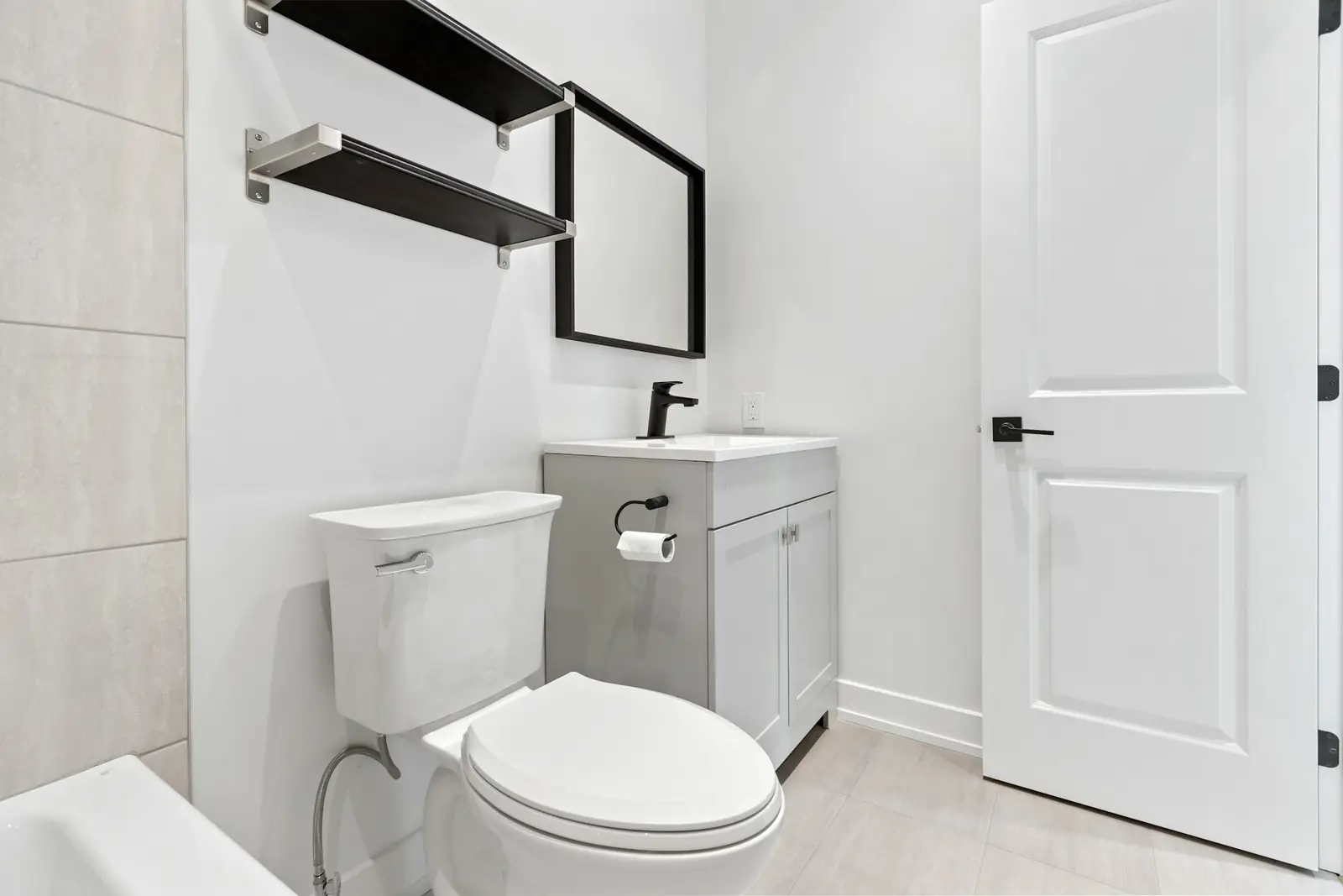 Small bathroom with a close-coupled toilet and grey vanity unit