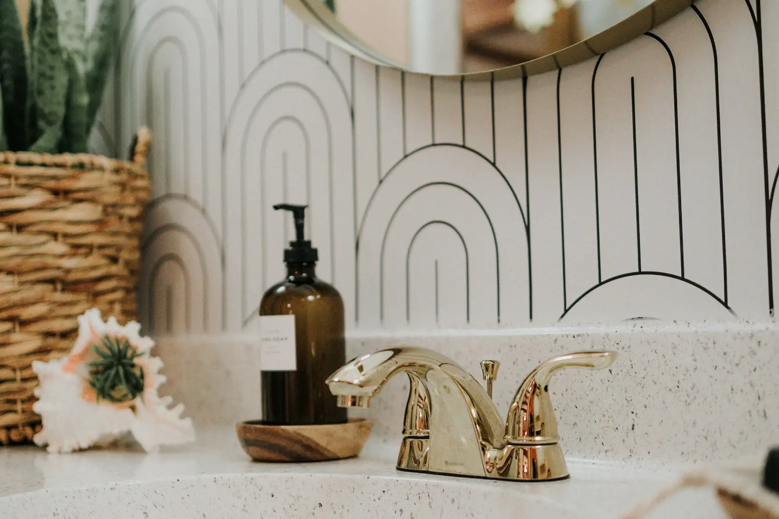 Brass basin taps on a vanity unit with soap and accessories