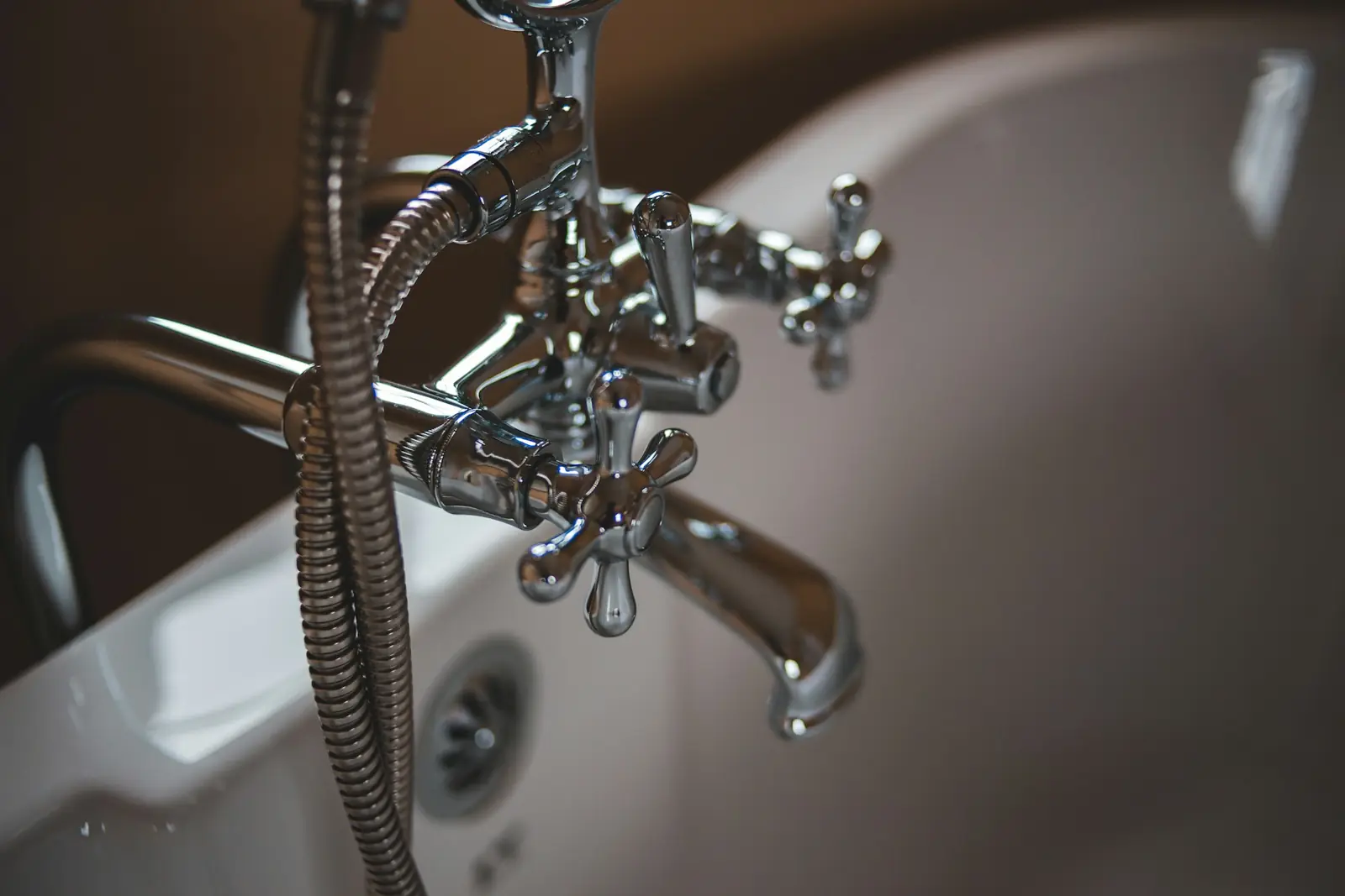 Chrome bath mixer tap with a shower handset