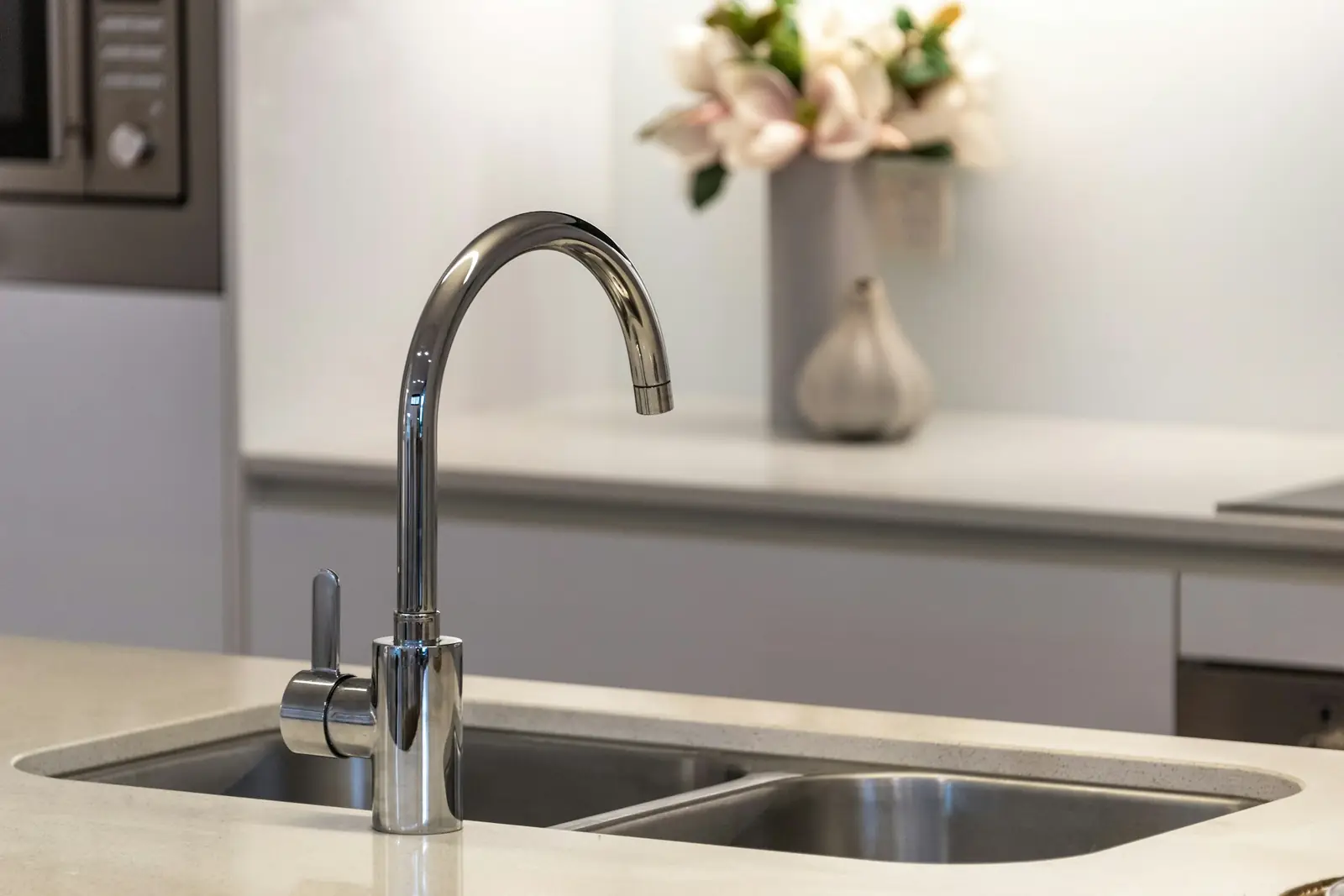 Chrome kitchen mixer tap over a stainless steel double sink