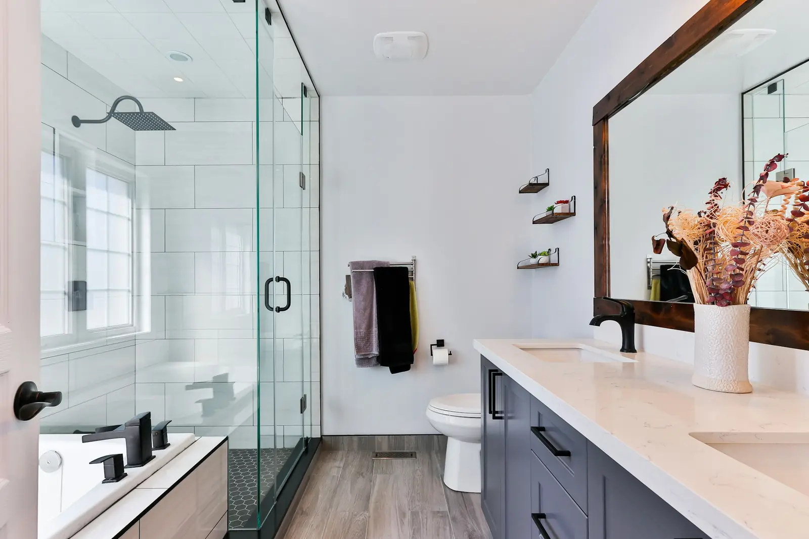 Bright shower room with a glass enclosure, toilet and vanity unit