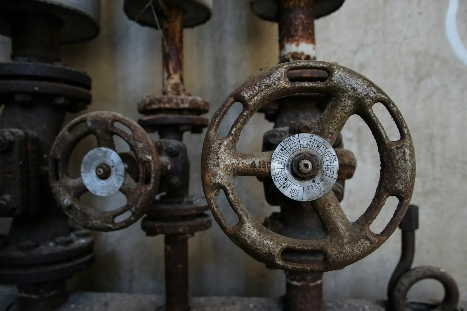 Old rusty gate valves on metal pipework