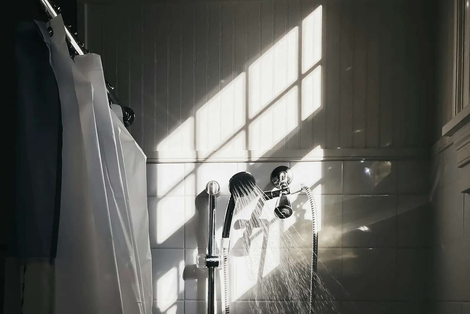 Shower handset on a riser rail with water running