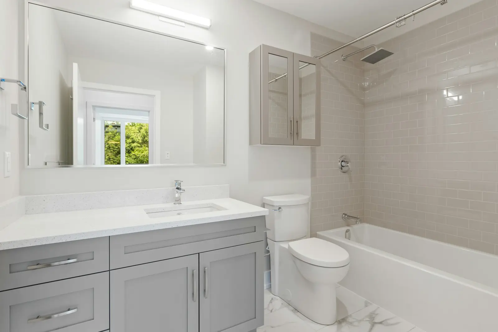White bathroom with a vanity unit, toilet and bath
